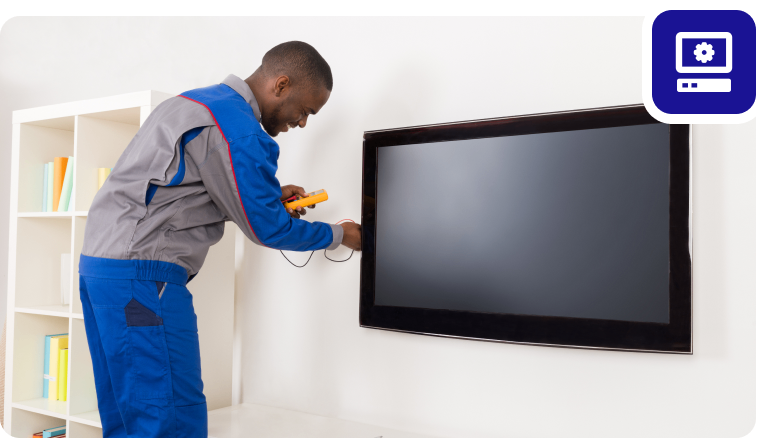 Group 1321315773 Technician working on flat-screen TV installation.